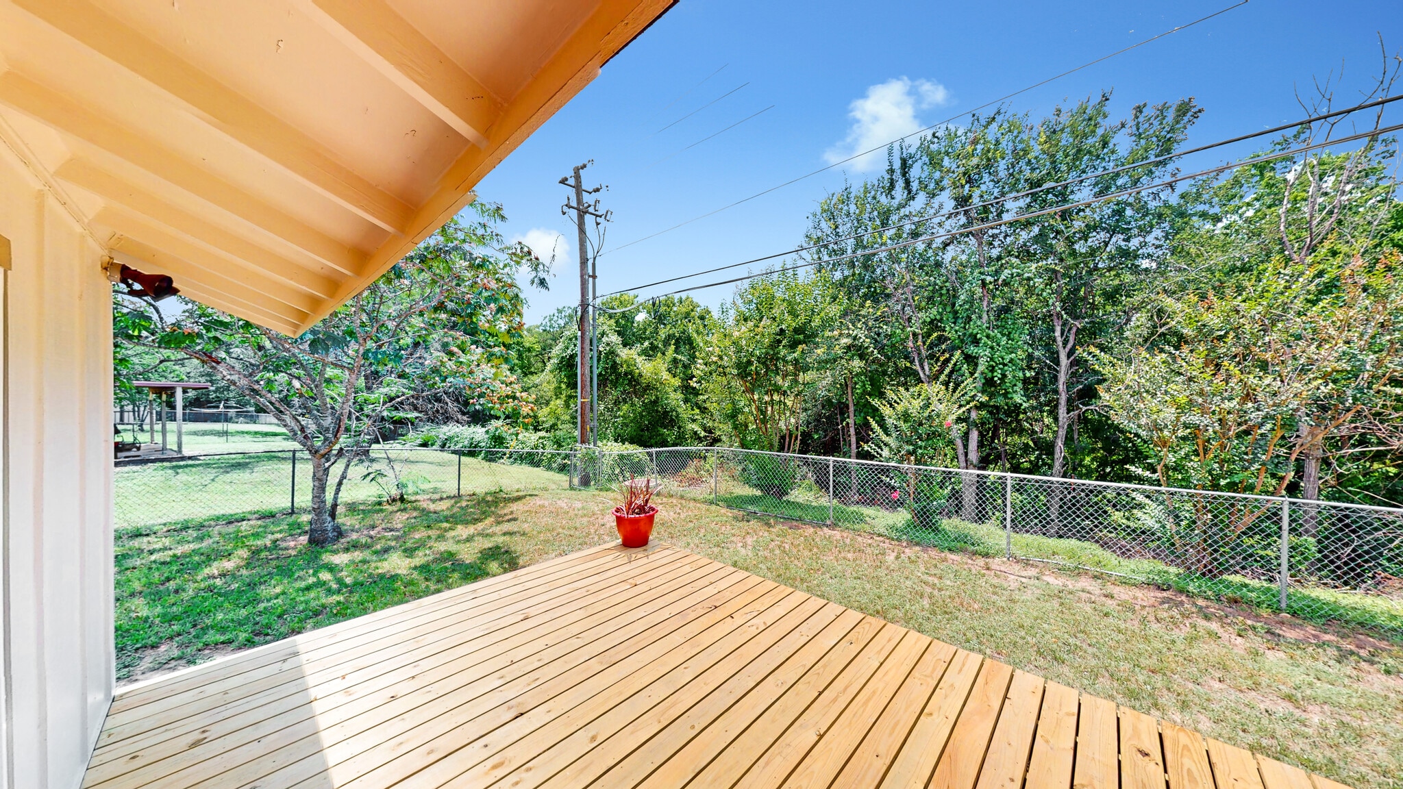 Deck featuring view of wooded area of Greenbelt - 5906 Wagon Bnd