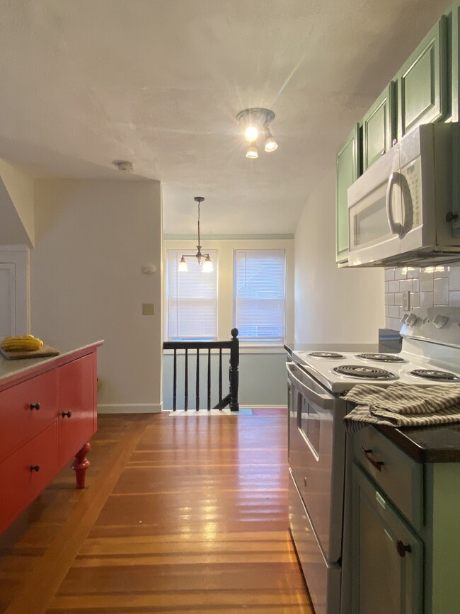 Open kitchen living area overlooking staircase. - 16 Eames St