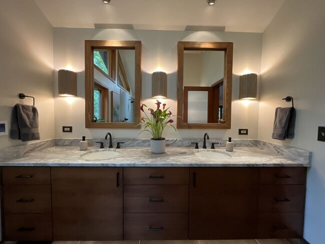Building Photo - One-of-a-Kind Custom Home with Wall of Windows, Stone Fireplaces, Expansive Entertainment Space &...