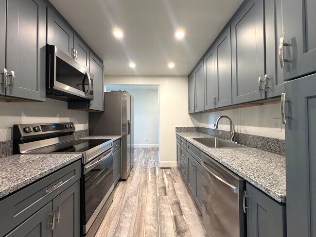 Building Photo - RENOVATED 3 bedroom end unit across the street from the Beach!