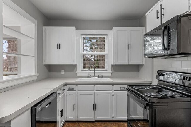 Building Photo - Brick home, Two Story, Hardwoods, DR, 2 Sun Rooms, FP, Carport!.