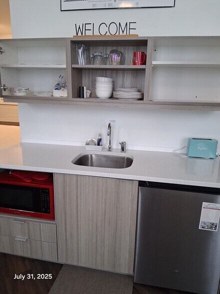 Kitchenette with microwave oven and under counter refrigerator - 818 12th St