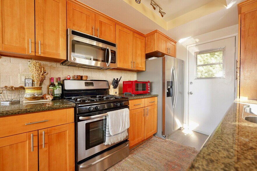 Upgraded kitchen with stainless and maple and Italian travertine - 3161 Weldon Ave