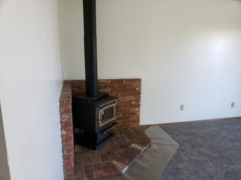 Wood stove in living room - 12202 E 10th Ave