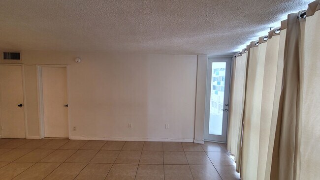 Livving Room (w/ balcony access door)) - 1228 West Ave