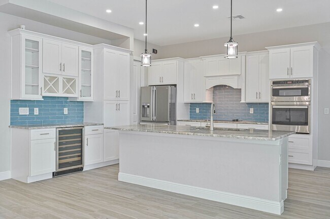 Building Photo - NOW AVAILABLE - Gorgeous Pool Home ~ NW Cape ~ 3 Car Garage ~ On Canal!