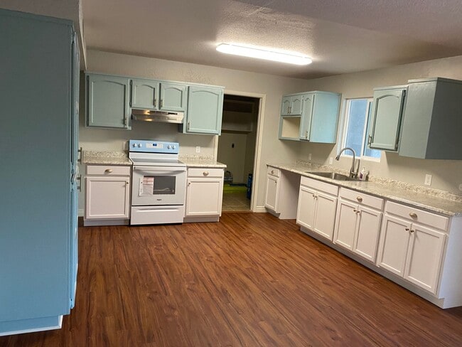 Building Photo - 3 bedroom home with large living room on a large corner lot with lots of room for play.