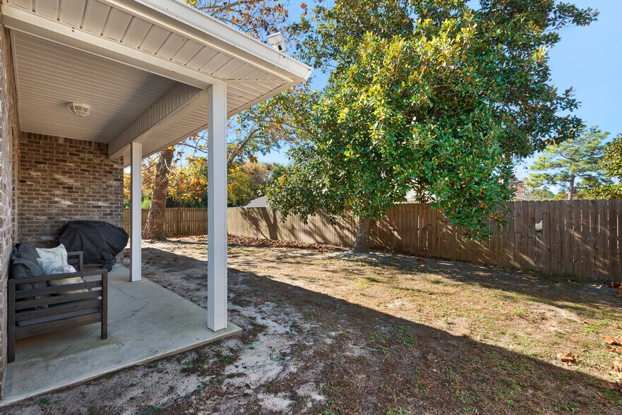 Backyard has a private fence, patio furniture, and barbecue - 28 Snook Rd