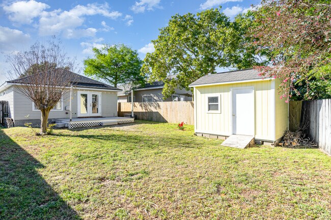 A spacious yard with a deck along with a privacy fence. - 6464 Starfish Cv