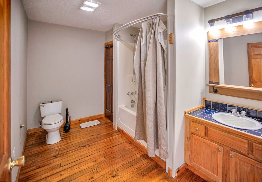 Down the hallway to the right is the bathroom. - 225 Depot St