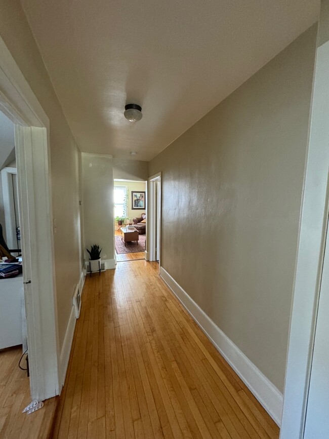 Hallway to living room from prior tenant 10-31-24 - 1618 N 6th St