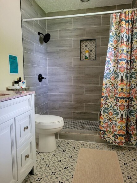 the bathroom features a large walk in shower - 5114 33rd St E