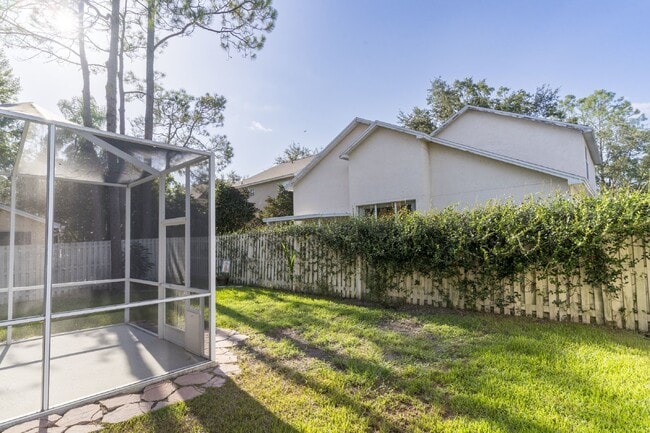 Building Photo - Beautiful 4/2 home Located on a tree lined street in the gate of country club community of the Hu...