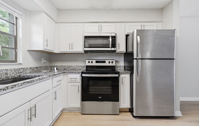 Building Photo - Expansive 2BR Downstairs Apartment Featuring a Fresh Remodel and Stainless Steel Essentials.