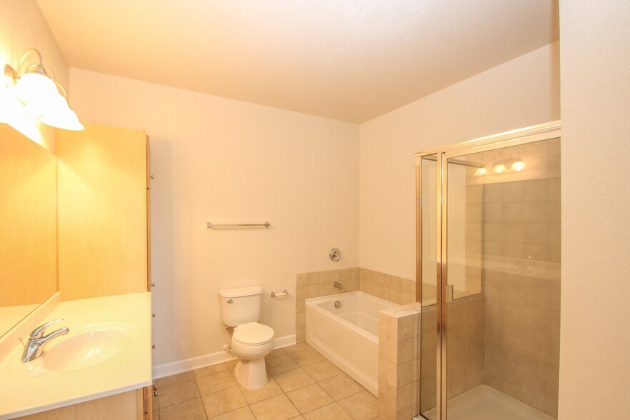 Full bathroom with soaker tub and ceramic tiles. - 1155 Ford Road