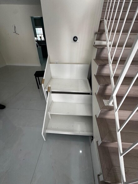 Under the stairs pull out shoe racks - 7432 Hazeltine Ave
