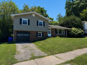 Building Photo - AVAILABLE NOW! Spacious 4 BR, 2 Bath House! Wood Floors, Attached Garage, W/D Included