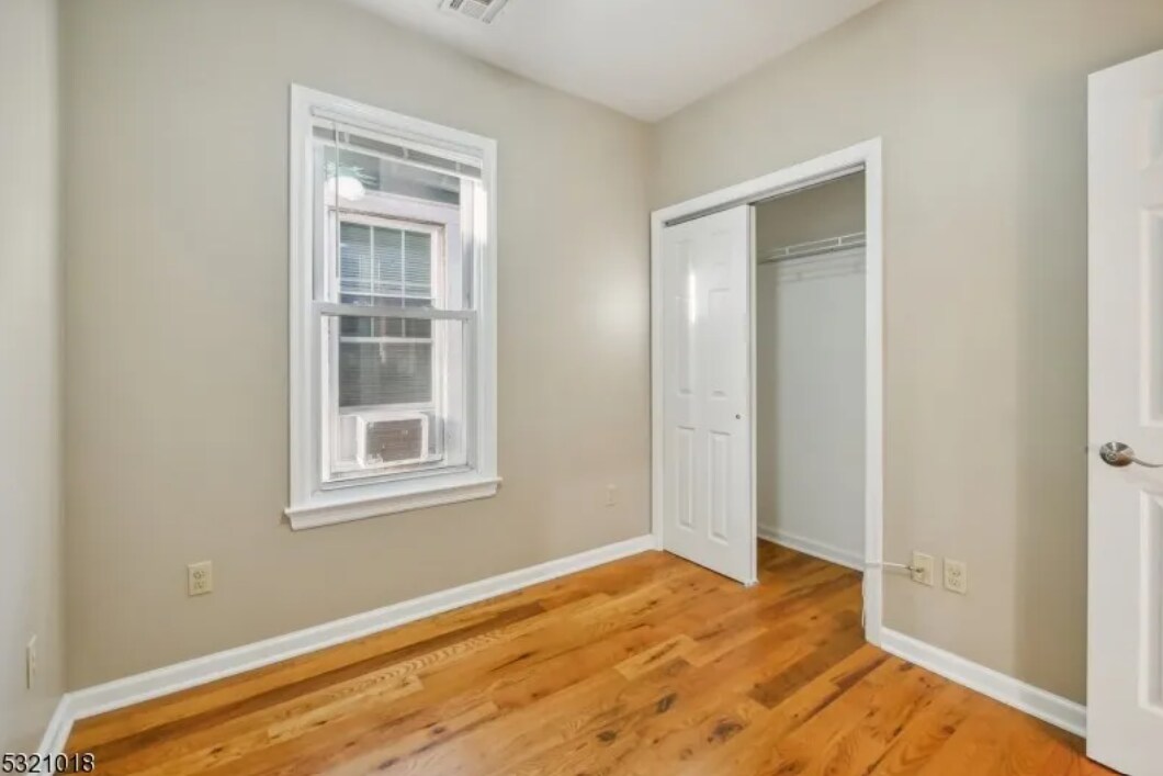 Bedroom One with Closet & Window - 53 Portland Pl