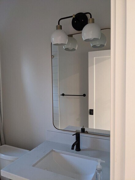 Bathroom sink with larger mirror - 3240 29th Ave W