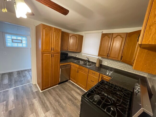 The kitchen includes a new stainless dishwasher and five burner gas range - 212 Lorenz Ave