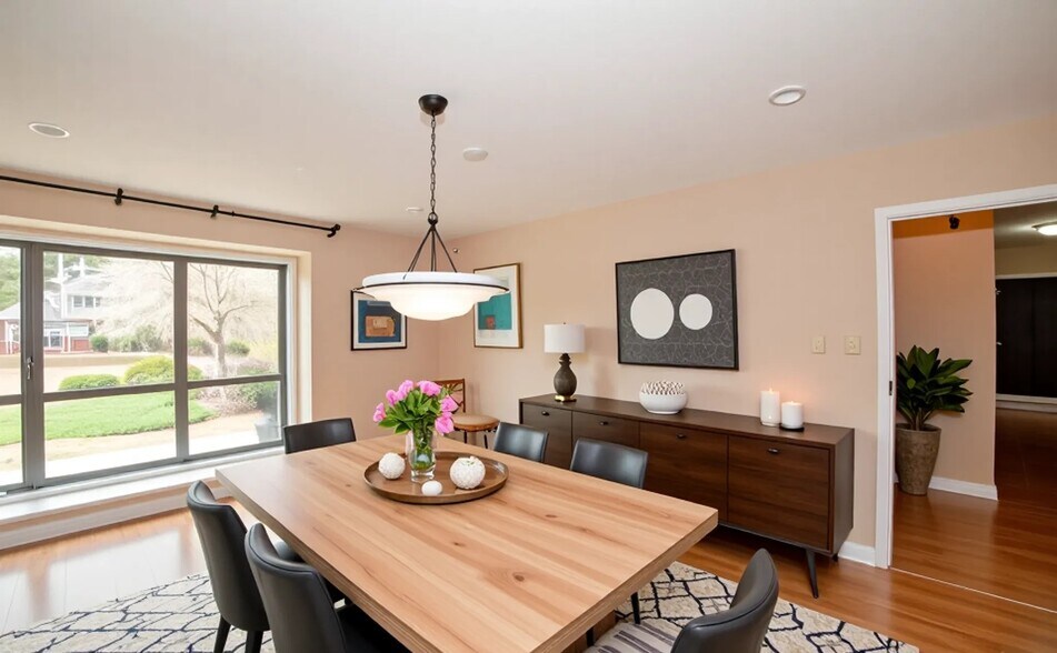Dedicated dining area with large windows and warm lighting (virtually staged). - 6812 Uppingham Rd