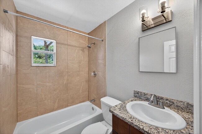 Building Photo - Spacious 2 bed apartment with fenced courtyard, parking, payment plans available for security dep...