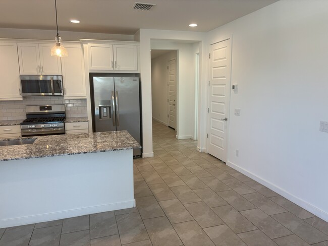 kitchen and walkway - 12350 W Wagon Wheel Dr
