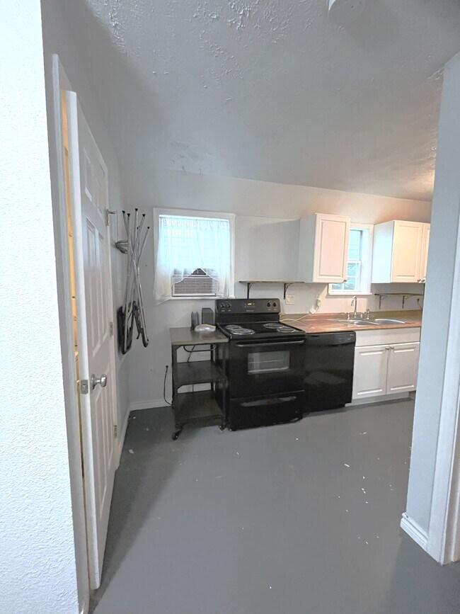 Partial view of kitchen. Bathroom is on the left and bedroom is on the right. - 1127 Walling St