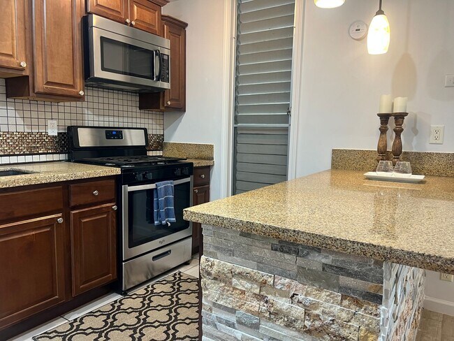 Building Photo - One bedroom semi-furnished bottom floor condo