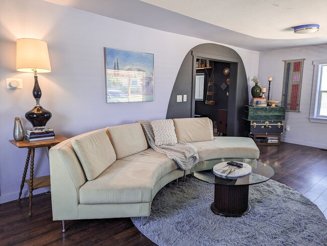 The living room has ample space for hanging out, Yoga and fitness, and a large TV for shows or games - 5410 Monaco St