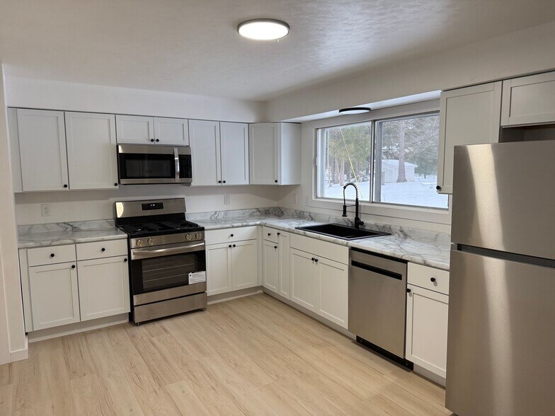 Open-concept living area with abundant natural light in this updated Wisconsin Rapids apartment. - 1310 21st Ave S
