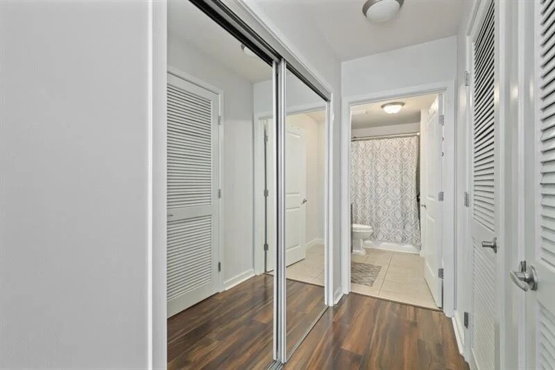 large mirror sliding doors reveal spacious closet - 860 Peachtree St NE