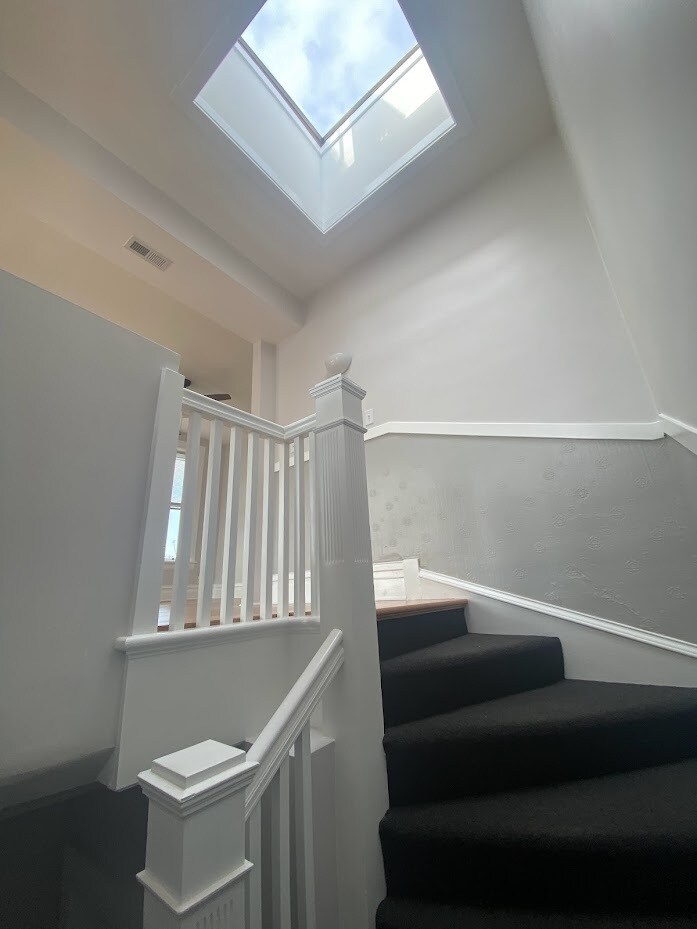 stairwell entry with skylight - 4200 N Damen Ave