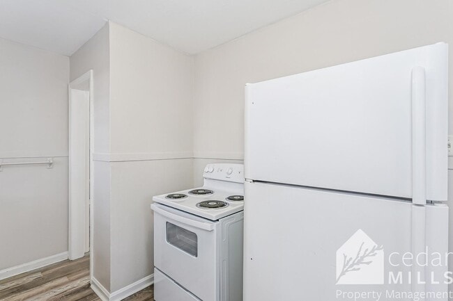 Building Photo - Updated, clean unit, with LARGE basement for storage!