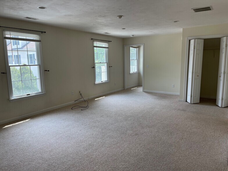Living room, with door to stairway to top floor with primary suite - 24 Spring Bars Rd