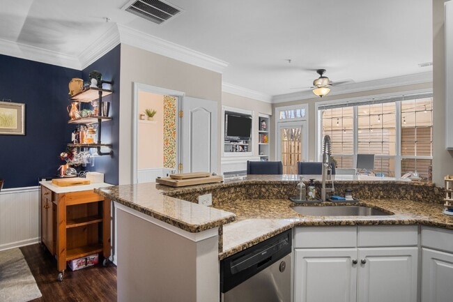 Building Photo - This inviting two-level townhome offers comfort and style, featuring gleaming hardwood floors on ...