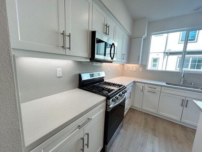 Building Photo - Gorgeous, 3 level townhome, featuring 2 car garage central Air, and in Unit laundry.