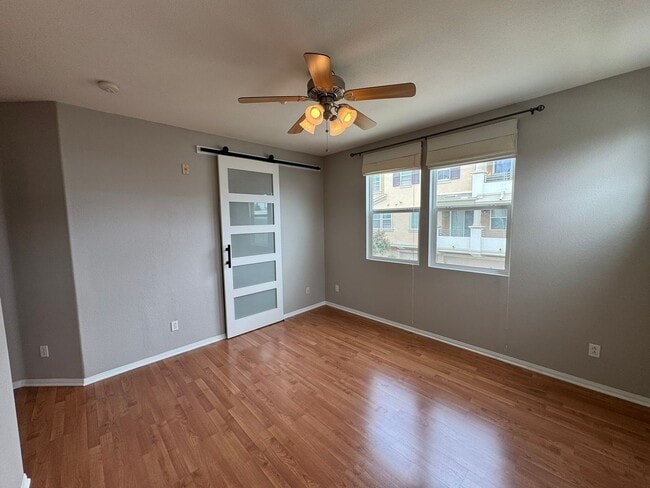 Building Photo - Sleek 2-Bed with a Den/Office + Flex Corner Condo with Attached Tandem Garage