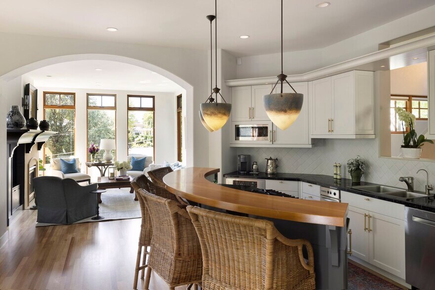 Fabulous gourmet kitchen with granite countertops, stainless appliances, and tiled backsplash - 745 Rice St E