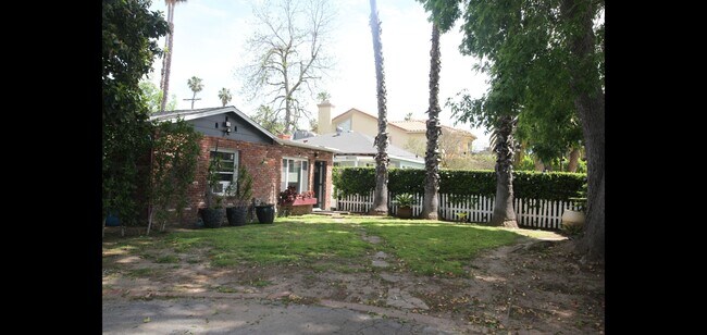 Taken from the driveway looking at the guest house front doors front window and also bedroom window - 14715 Addison St