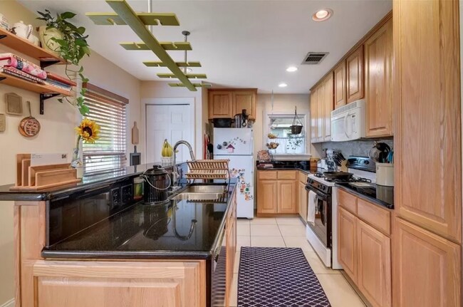 Building Photo - Discover Your Austin Oasis: Revitalized Bungalow with Hardwood Floors and Entertainer's Deck!