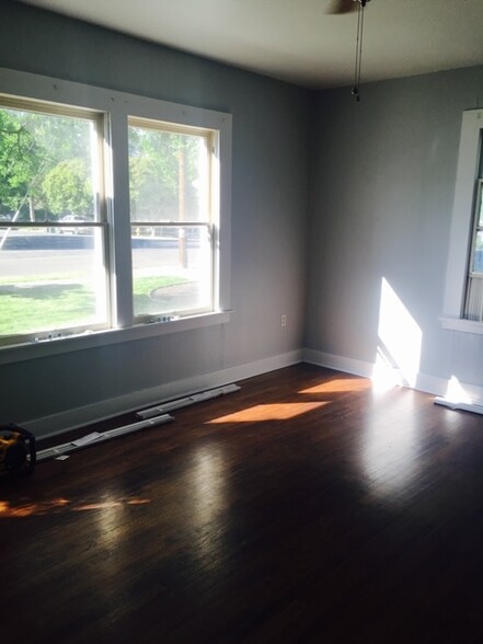 Living Space with hardwood floors and windows - 605 W 8th St