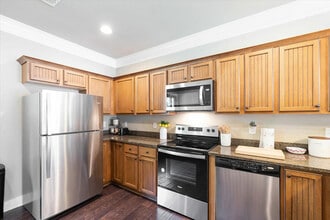 Enjoy modern, fully-equipped kitchens with granite counters and stainless steel appliances, perfect for student living. - The Cottages of Hattiesburg