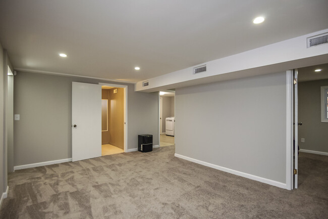 Photo 18. Lower level Family Room/Game Room opens to Third Bedroom, Second Full Bathroom, and Washer - 1623 Lethia Dr