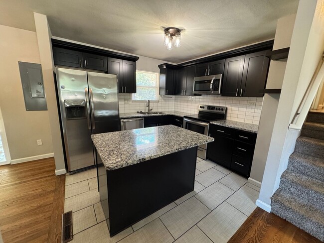 Building Photo - Stylish Tri-Level with Bonus Living Space ...