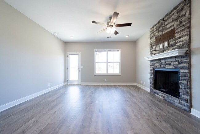 Building Photo - Elegant Home with Stone Fireplace, Kitchen Island and Designer Primary Suite