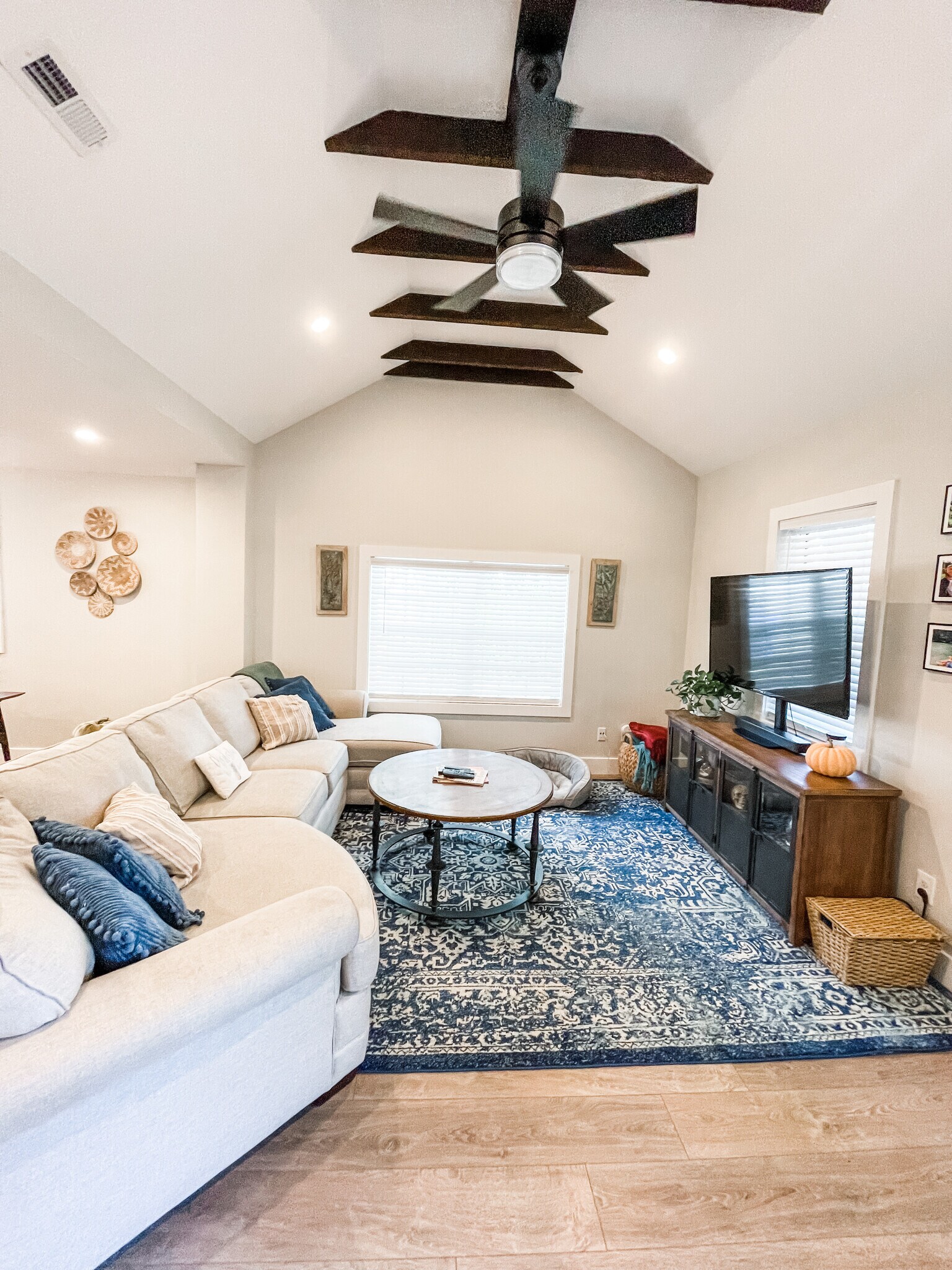 Vaulted ceiling in living room with original beams and ceiling fan - 303 Woodland Shores Rd