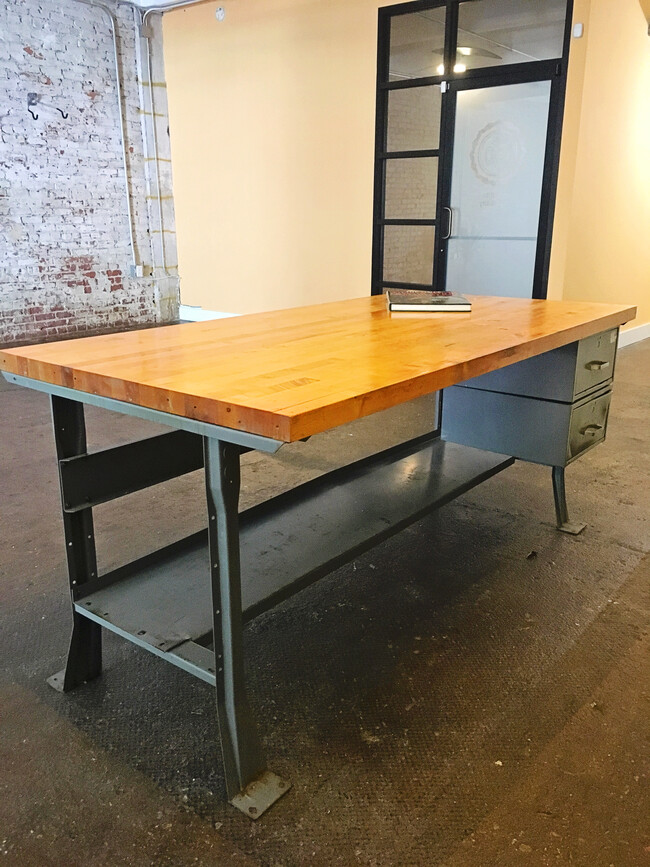 Sturdy 6'x3' foot kitchen island, which once served as an industrial work table, features thick butcher block top, 2 drawers and additional storage below. - 659 Auburn Ave NE #145