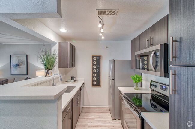 Kitchen with Espresso Cabinetry and Stainless Steel Appliances - Stonelake at the Arboretum