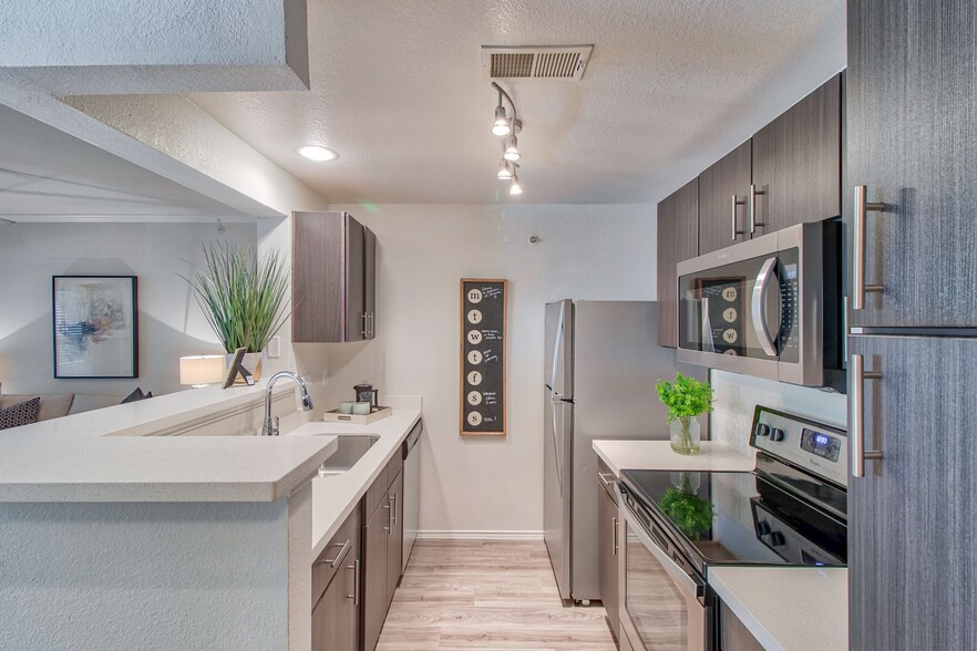 Kitchen with Espresso Cabinetry and Stainless Steel Appliances - Stonelake at the Arboretum